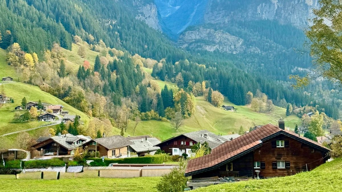 Beautiful view of Grindelwald village surrounded by lush greenery and majestic Alps.